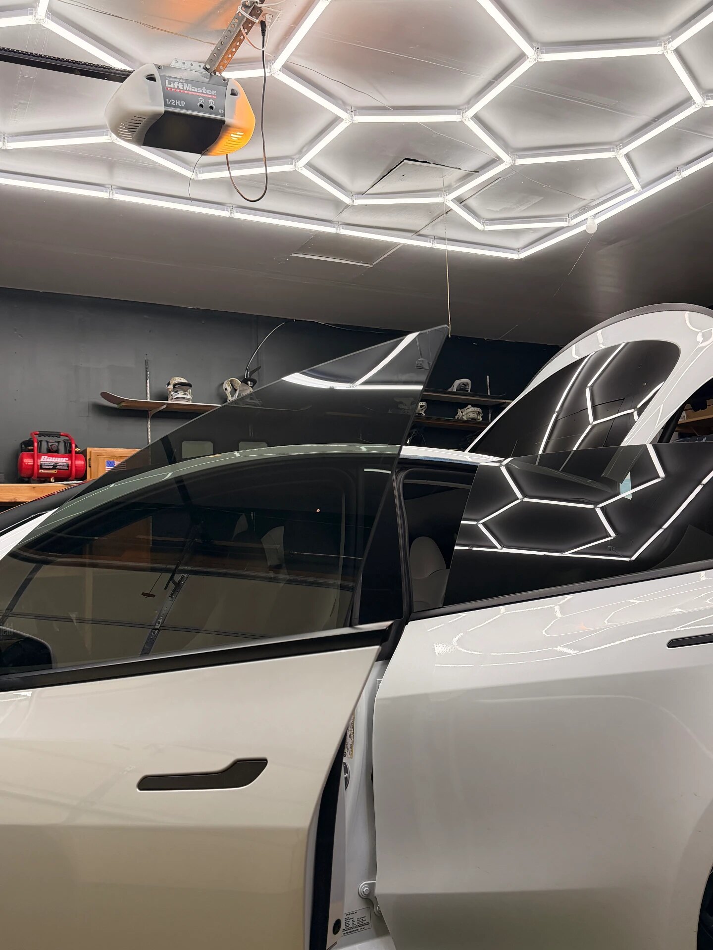 Tesla with freshly installed ceramic window tint in the Jungle Tint studio in Riverton, Utah